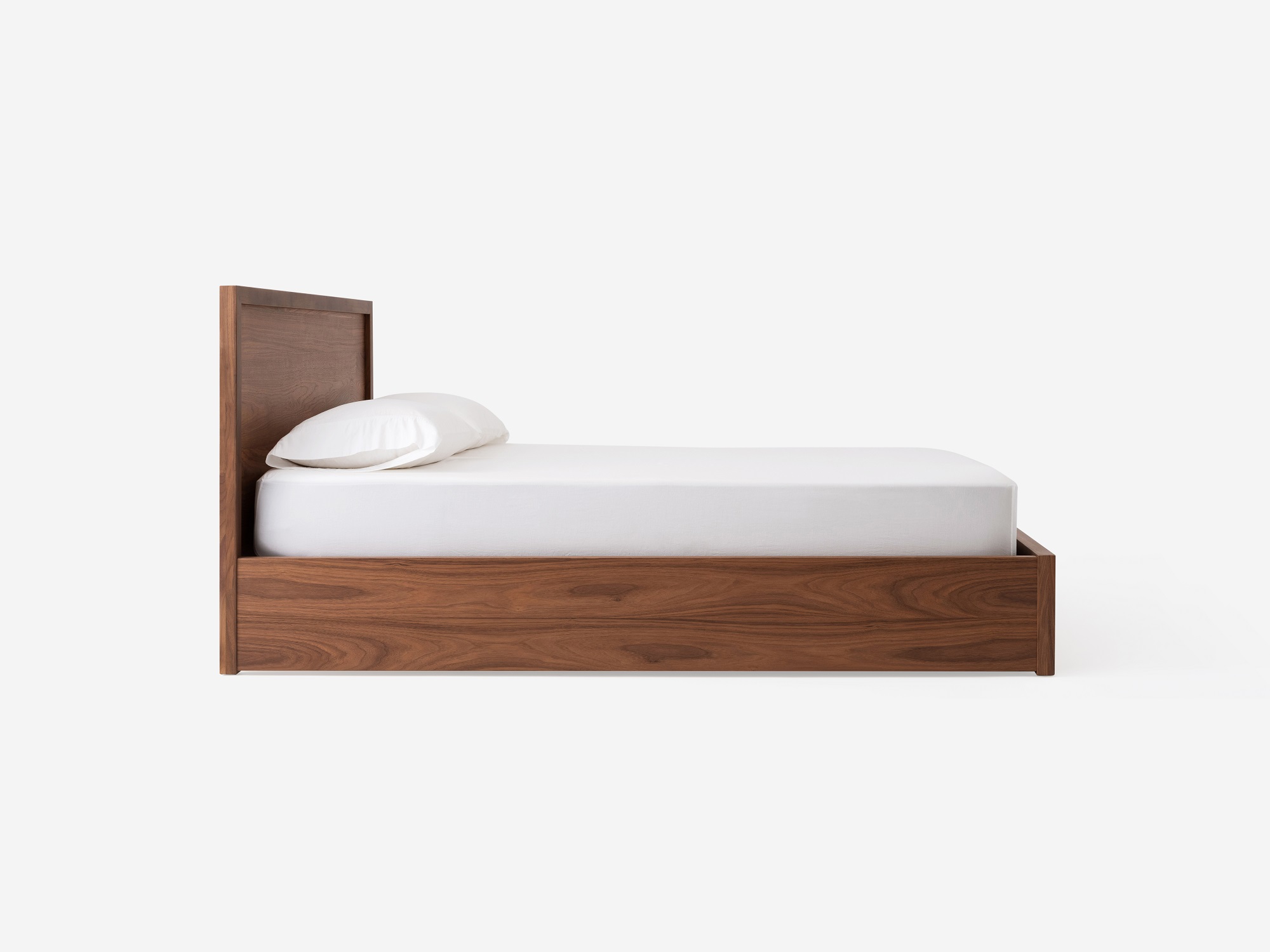 Side view of our walnut Marcel panel bed